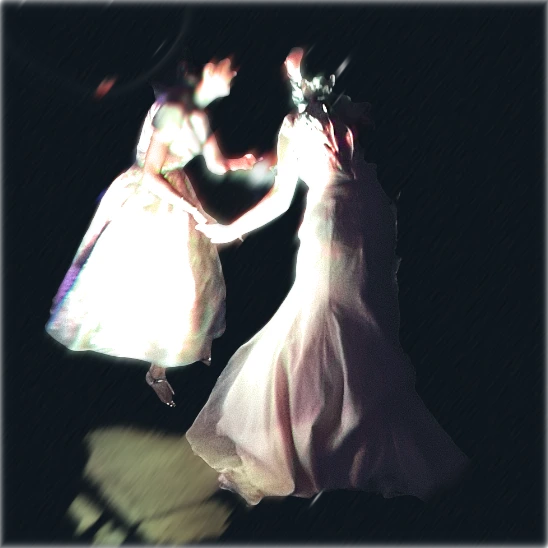 Dancers at a wedding in Ireland. Two women in white dance, hand in hand. Photograph copyright Tim Noel Smoth 2026